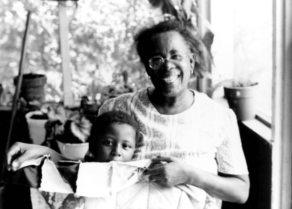 Portrait of Claudie Mae Hamilton With Child and One of Her Quilts in Gainesville Florida. Courtesy of Florida Memory Collection, Florida State Archives